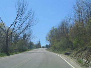 Heading south from Eades Road, CR 9 (Ossian Hill Road) increases in elevation from 650 to 1050 feet between NY 436 and CR 49 (McCurdy Road).