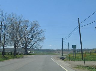 Ossian Hill Road enters the town of Ossian Hill at 970 feet in elevation.