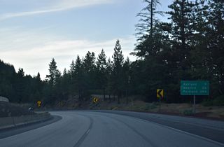 Interstate 5 continues north from the Siskiyou Mountains on a gradual descent nine miles to Ashland. A previous distance sign that was removed by 2007 was located a mile further south.