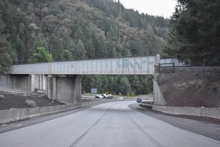 The Central Oregon &amp; Pacific Railroad parallels I-5 to the west before navigating through a switch back and then turning south over the freeway by mile marker 7. The railroad makes a second switch back east of I-5 to resume north to Ashland.