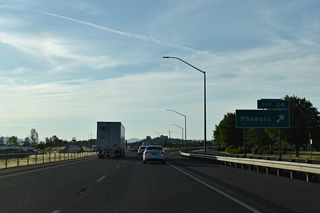 A realignment of N Phoenix Road replaced Fern Valley Road west across Interstate 5 to 0.4 miles to OR 99 (Main Street). Turning north from Exit 24, the arterial narrows to two lanes ahead of Centennial Golf Club in Medford.