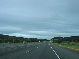 A barrier median separates the roadways along I-5/OR 99 (Pacific Highway) where the freeway heads west to Hidden Valley.