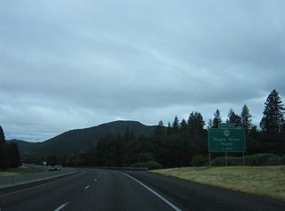 OR 99 heads west from Gold Hill to Rock Point, where the highway turns south across Rogue River on a concrete arch bridge built in 1920. ODOT signs OR 99 east from the access road at Exit 43 to Gold Hill dually with OR 234, despite inventorying the Gold Hill Spur from Exit 40 as OR 234.