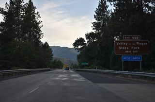 Interstate 5 crosses the Rogue River southwest ahead of the folded diamond interchange (Exit 45 B) with the access road to Valley of the Rogue State Park.