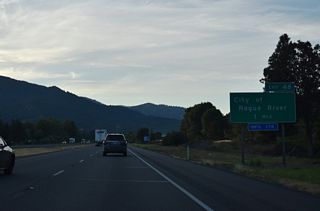 The diamond interchange (Exit 48) with Depot Street links I-5 with OR 99 (Rogue River Highway) and Main Street in Downtown Rogue River. Pine Street and West Evans Creek Road head north into the adjacent mountains. 