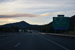 Forthcoming Exit 58 joins the freeway with the one way couplet of OR 99 along 6th/7th Streets in north Grants Pass. OR 99 travels through Downtown to U.S. 199 (Grants Pass Parkway / Redwood Highway) and OR 238 (Williams Highway).