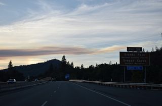 Exit 58 serves the National Historic District of Grants Pass.  Oregon Caves National Monument is 19 miles east of U.S. 199 (Redwood Highway) via OR 46 (Caves Highway) from Cave Junction. A marble cave lies below and old coniferous forest that includes the widest known Douglas-fir tree in Oregon. 