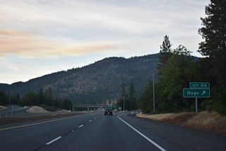 Northbound at the modified diamond interchange (Exit 66) with Monument Drive and Jumpoff Joe Creek east. A local trapping party camped along Jumpoff Joe Creek in 1828 when member Joe Mcloughlin arrived after dark and fell from a cliff nearby. Mcloughlin sustained severe injuries from the fall.