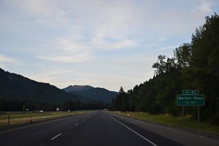 Paralleling Cow Creek, I-5 advances 0.75 miles east to a half diamond interchange (Exit 83) with Barton Road. Barton Road links the freeway with Azalea-Glen Road (Old U.S. 99), 0.4 miles to the north.