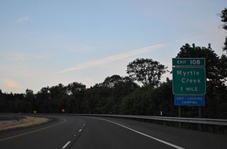 Paralleling the South Umpqua River, Interstate 5 navigates through a series of S-curves north to Exit 108 for OR 99 (N Main Street) into the city of Myrtle Creek.