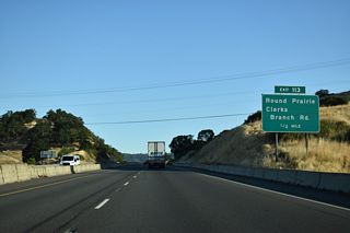Clarks Branch Road meets Interstate 5 at a diamond interchange (Exit 113) adjacent to Dole Road.