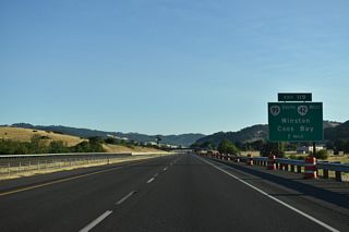 The east end of OR 42 (Coos Bay-Roseburg Highway) ties into the trumpet interchange at Exit 119.