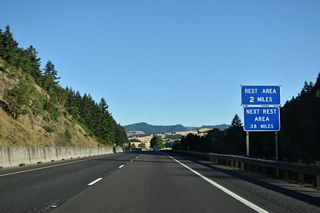 OR 99 rejoins Interstate 5 north from a wye interchange (Exit 140) joining the freeway southbound with Oakland. The Cabin Creek Rest Area follows in two miles.