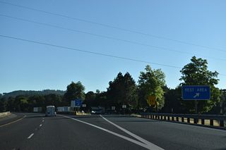 The Cabin Creek Rest Area lines the northbound roadway adjacent to Cabin Creek and the Southern Pacific Railroad ahead of mile marker 143. 