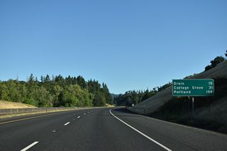 Curving northeast Interstate 5 lowers from Rice Hill Summit (elevation 723 feet) into Rice Valley.