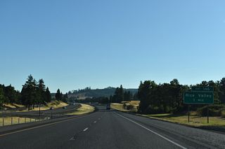Rice Valley Road parallels the west side of I-5 north to the parclo interchange at Exit 146.