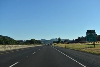 OR 99 separates from I-5 again at the trumpet interchange (Exit 150) with John Long Road south and Eagle Valley Road north. OR 99 heads 2.4 miles north to Yoncalla and 7.8 miles to OR 38 west at Drain. OR 99 loops back to I-5 at Exit 161 near Curtin. 