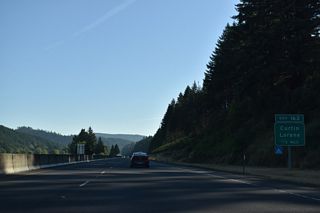 Curtin Road (Old U.S. 99) heads northeast from Territorial Highway (CR 116) to the unincorporated community of Curtin. Bear Creek Road stems east from Curtin to Pass Creek Park and the parclo interchange at Exit 163.
