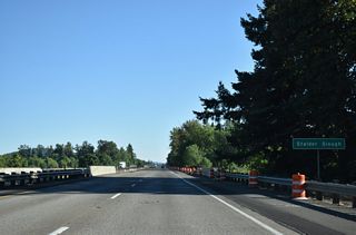 Interstate 5 crosses Stalder Slough adjacent to pasture land along the Coast Fork of the Willamette River.