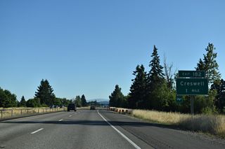 Oregon Avenue east and Cloverdale Road west come together at forthcoming Exit 182 in the city of Creswell. OR 99 dog legs east from Front Street onto Mill Street along Oregon Avenue a third of a mile to the west of I-5.