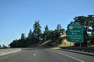 I-5/OR 99 travels through Coryell Pass before curving west into the city of Eugene and a parclo interchange (Exit 191) with Glenwood Boulevard.
