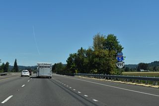 Reassurance markers for I-5/OR 99E north precede the bridge across Morgan Creek.