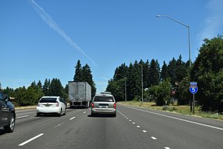 North of Exit 283, Interstate 5 passes between an area of warehouses / distribution centers and Wilsonville Town Center.