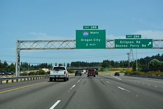 Exit 286 leaves I-5 north for Elligsen Road east and Boones Ferry Road (OR 141) north. A large industrial park spreads to the west and Argyle Square Shopping Center lines Elligsen Road to the east. Interstate 205 splits with I-5 in two miles at Exit 288.
