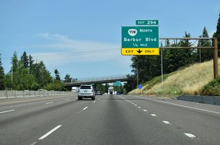 Turning northeast into Portland, Interstate 5 converges with OR 99W (Barbur Boulevard) at Exit 294 between the Crestwood and Far Southwest neighborhoods.