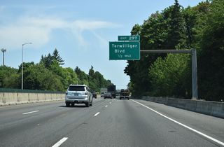 Continuing northeast by the Multnomah neighborhood, the succeeding exit departs in a half mile for Terwilliger Boulevard.