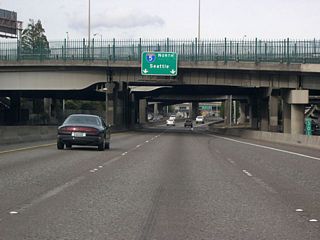 Once off the Marquam Bridge at milepost 301, northbound I-5 enters a labyrinth of overpasses and flyover ramps. Except for some auxiliary lanes, northbound traffic reduces to two lanes until just past the northern interchange with I-405.