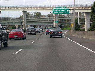 High flyovers connect I-5 with the Fremont Bridge above Exit 302 A for Greeley Avenue. The Stadium Freeway spurs northeast from this exchange to Kerby Avenue at Gantenbein Avenue. Intended to continue northeast to the unconstructed Prescott Freeway as the Rose City Freeway, the freeway stub  provides local access to Martin Luther King, Jr. Boulevard (OR 99E) at the Boise section of the city.