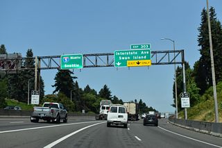 The flyover from I-405 (Stadium Freeway) adds two lanes to I-5 northbound at Albina in Portland. A trumpet interchange (Exit 303) follows with Going Street west to Interstate Avenue (former OR 99W) and Swan Island.