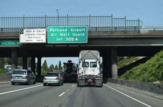 Northbound I-5 passes under Rosa Parks Way. Lombard Street (U.S. 30 bypass) east leads to Portland International Airport (PDX) from forthcoming Exit 305 A.