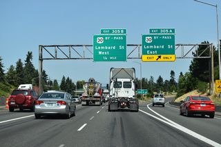 Prior to completion of the Banfield Freeway (I-80N/84), U.S. 30 followed two primary routes in Portland: the business route split from the bypass in Parkrose and followed Sandy Boulevard to the Burnside Bridge and the city center. The bypass route followed Portland Highway / Lombard Street along northern reaches of the city. Crossing the St. Johns Bridge, the two branches rejoined at the western end of the Willamette River.