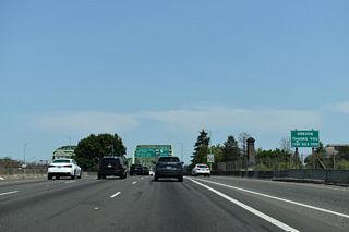 Continuing onto the Interstate Bridge, a sign thanks motorists for visiting Oregon.