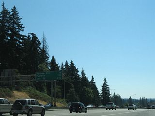 Southbound traffic merges onto I-5 (Baldock Freeway) from the diamond interchange (Exit 291) with Upper Boones Ferry Road / Carman Drive a half mile north of Exit 290 to Durham. The freeway straddles the Clackamas County line along this stretch.