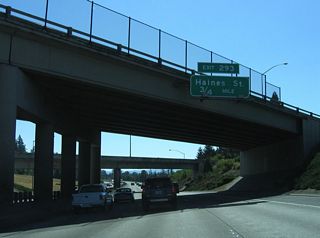 Curving southward again, Interstate 5 proceeds 0.75 miles to Exit 293 with SW 68th Avenue and Dartmouth Street in the city of Tigard.