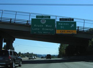 Exit 293 departs I-5 south at the Atlanta Street overpass. Atlanta Street east becomes Haines Street within the Far Southwest neighborhood of Portland. 68th Avenue runs southward from Atlanta Street to commercial areas alongside the freeway. Darmouth Street spurs west to OR 99W (Pacific Highway).