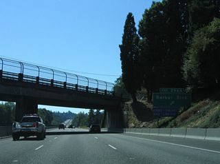 A pair of loop ramps a Exit 296 join Interstate 5 and Barbur Boulevard at Spring Garden Street. OR 99W remains parallel to I-5 along a commercial arterial to Crestwood and West Portland Park.