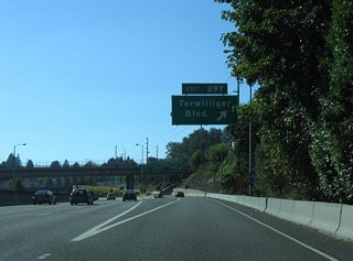 Exit 297 departs Interstate 5 south for Barbur Boulevard (OR 99W) at Bertha Boulevard. Heading south to South Burlingame and Lewis and Clark College and north to Hillsdale and Capitol Highway (OR 10), Terwilliger Boulevard intersects Barbur Boulevard to the east.