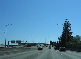 Leading south to the Marquam Bridge, ramp stubs remain both sides of I-5 southbound roadway for the unconstructed Mount Hood Freeway. The unbuilt freeway was a proposed realignment of U.S. 26 east along Division Street to the Richmond neighborhood, and along Powell Boulevard through South Tabor.