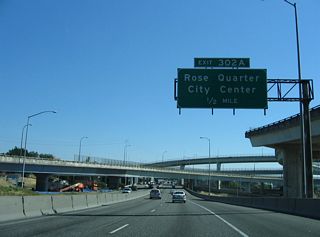 Exit 302 A connects I-5/U.S. 30 south to Broadway west at the Rose Quarter. Portland's Rose Quarter includes the Moda Center and Veterans Memorial Coliseum. Moda Center opened in 1995 as the home of the Portland Trailblazers. The Western Hockey League Portland Winterhawks split their home games between the two arenas.