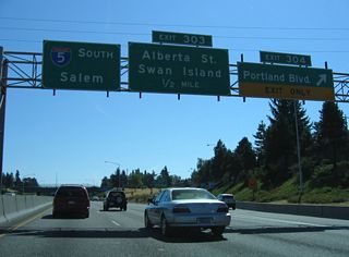 Exit 304 leaves I-5 south for Rosa Parks Way (former Portland Boulevard) ahead of the split diamond interchange (Exit 303) with Alberta Street. Rosa Parks Way runs east through the Piedmont neighborhood to Martin Luther King, Jr. Boulevard (OR 99E).