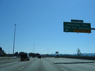 Denver Avenue (former OR 99W) separates from I-5 south at a wye interchange (Exit 306). A parclo interchange nearby joins Denver Avenue with Victory Boulevard and Expo Road at Portland International Raceway. Interstate Avenue (former U.S. 99W) parallels I-5 (Minnesota Freeway) south through Arbor Lodge and Overlook.