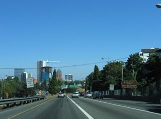 Lowering east from the Vista Ridge Tunnel, the Downtown Portland skyline comes into view.