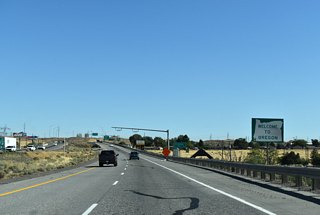 A welcome sign precedes the 3rd Street under crossing. A tourist information center lies off Exit 1 along U.S. 730 (6th Street).