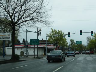 A guide sign for Interstate 105 appeared at 6th Avenue and Charnelton Street, two blocks ahead of the entrance ramp for the freeway north across the Willamette River. This panel was removed by 2008.