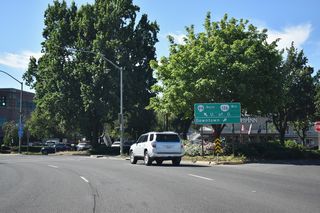 Two lanes from Coburg Road tie into OR 99/126 south on Mill Street at E 8th Avenue. Mill Street proceeds south onto Broadway at the succeeding intersection.