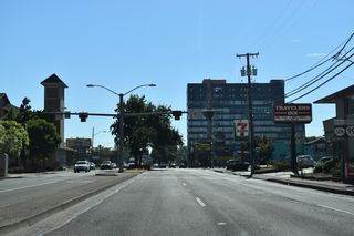 Broadway constitutes a five lane boulevard east from Mill Street to Hiyard Street, where SR 99/126 Business westbound turn north. Reassurance markers for the state routes precede the HaWK signal between Ferry and Patterson Streets.